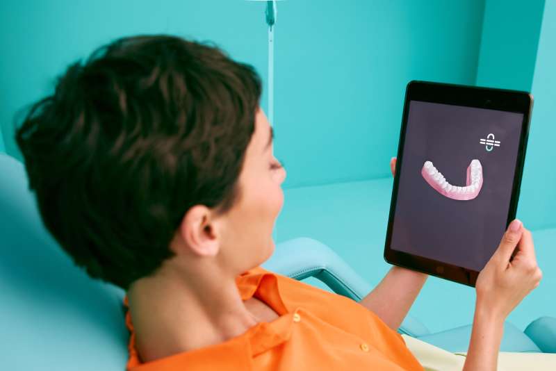 [CRO/DO NOT USE] Medical - Woman - Chair - Clinic - 3D iPad - Blue - Background - Desktop